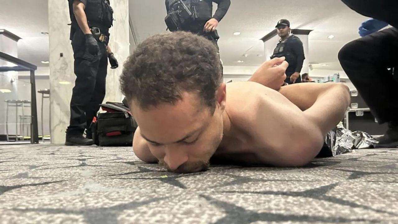 President Trump shared this photo appearing to show the shirtless suspect on the floor of the Washington Hilton hotel